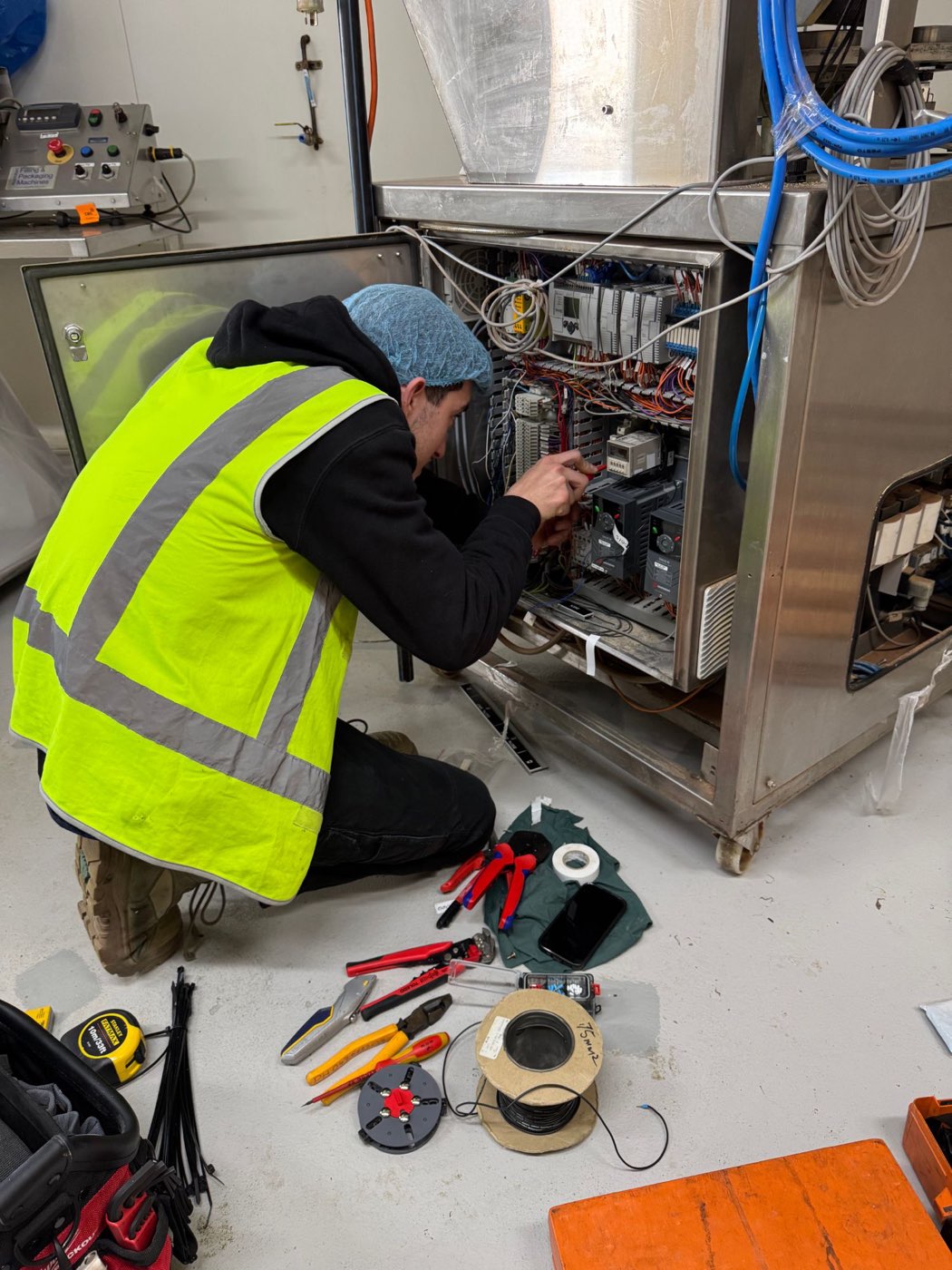 Prophase Data & Electrical technician servicing an industrial control panel